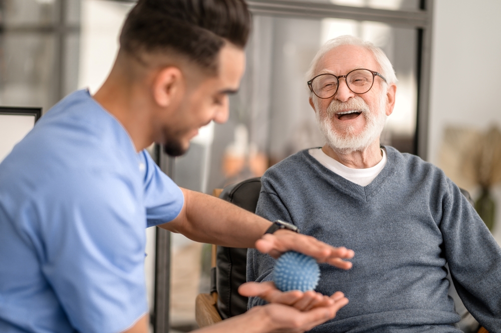 Aging support worker with elderly man