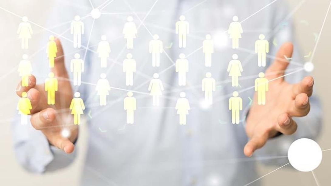 Man holding out hands with interactive figures of people appearing between them.