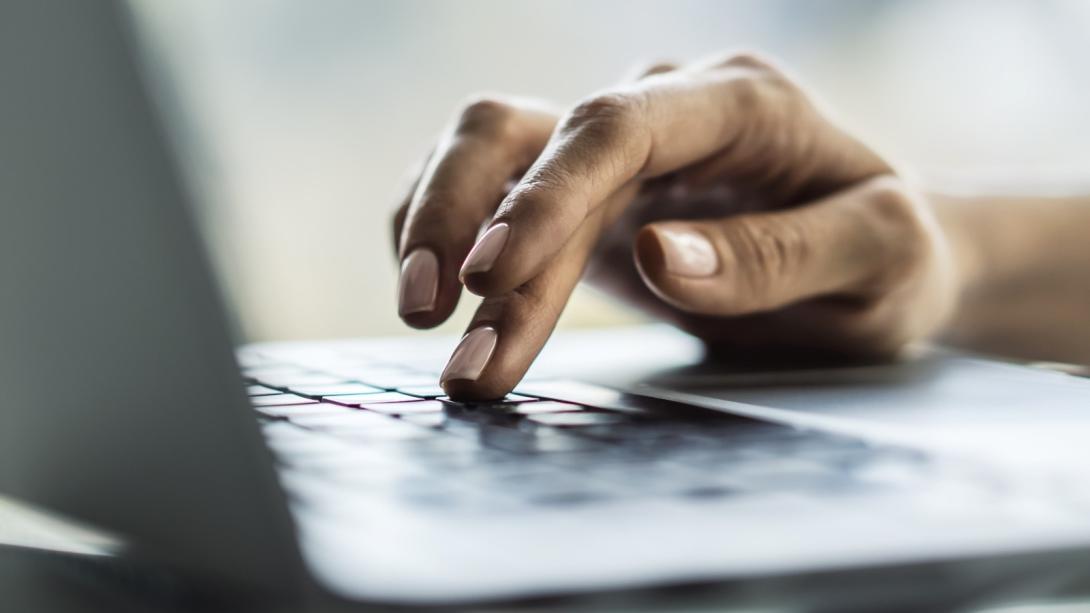 Person clicking laptop