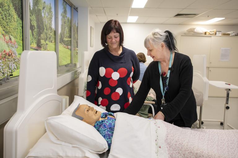 Nurse teaching student in hospital setting