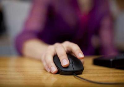 Hand using computer mouse. 