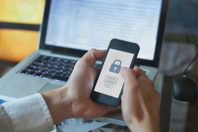 Mobile and laptop user logging in to online account