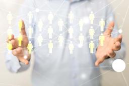 Man holding out hands with interactive figures of people appearing between them