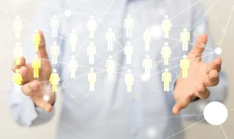 Man holding out hands with interactive figures of people appearing between them.