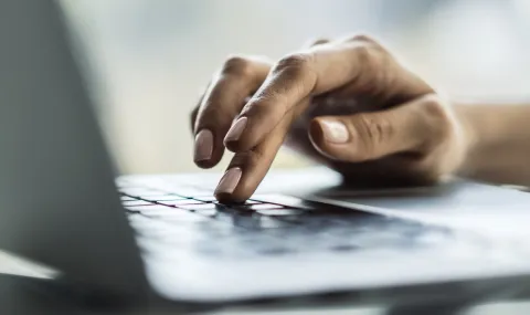 Person clicking laptop