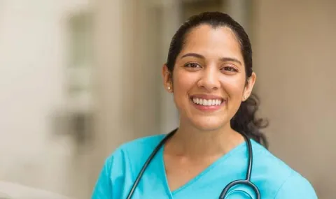 Smiling female doctor with a stethoscope around her neck in the hospital corridors